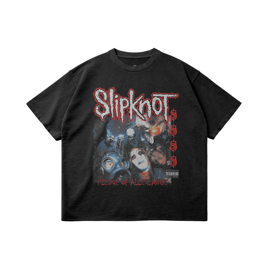 A black oversized t-shirt featuring a graphic design of the band Slipknot with their iconic logo in distressed red lettering at the top. Below the logo, there is a collage of masked band members and imagery. The text "PLEDGE OF ALLEGIANCE" is displayed in red at the bottom of the design.