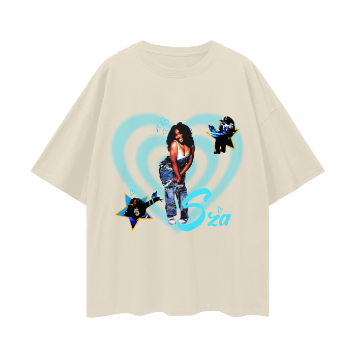A beige oversized t-shirt featuring a collage of the artist SZA in the center, surrounded by blue hearts. The design includes two smaller images of SZA inside yellow stars, positioned on the left and right sides of the shirt. The name "SZA" is written in a playful blue font near the bottom right of the design.