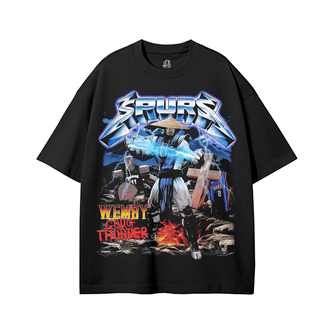 Black heavyweight drop shoulder t-shirt featuring a Mortal Kombat Raiden warrior graphic representing Victor Wembanyama, with lightning effects, Spurs-themed artwork, dramatic gaming-inspired visuals, and bold basketball streetwear styling.